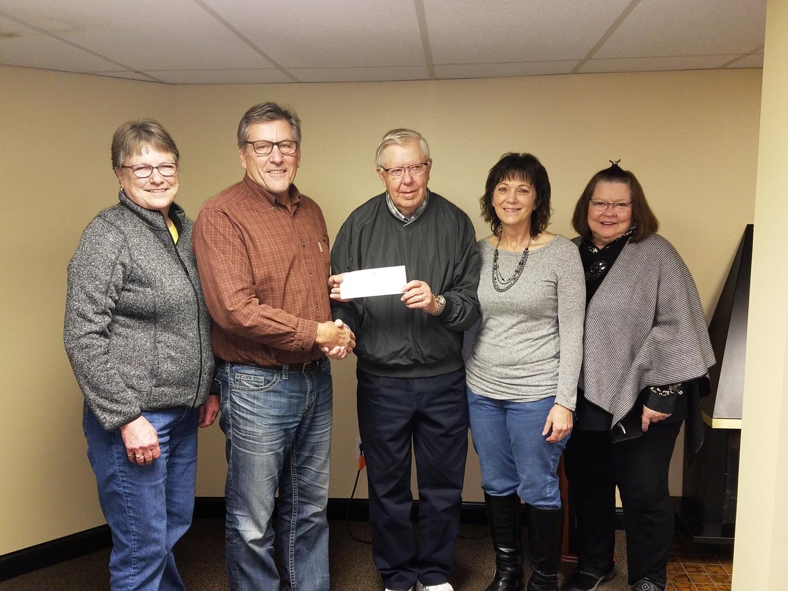 Traverse Electric General Manager Clayton Halverson presents a check to representatives from the Rosholt Housing and Redevelopment Commission